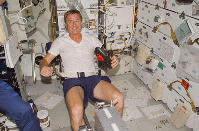 NASA image: Culbertson, Jr. exercises on the bicycle ergometer