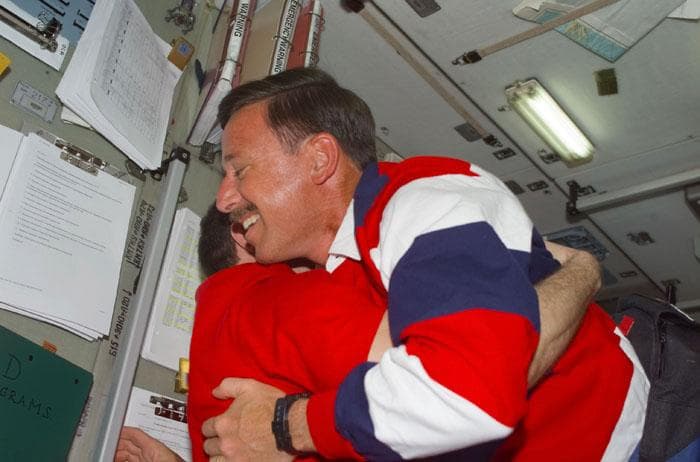 NASA image: Horowitz is hugged by Usachev in the ISS Service Module/Zvezda
