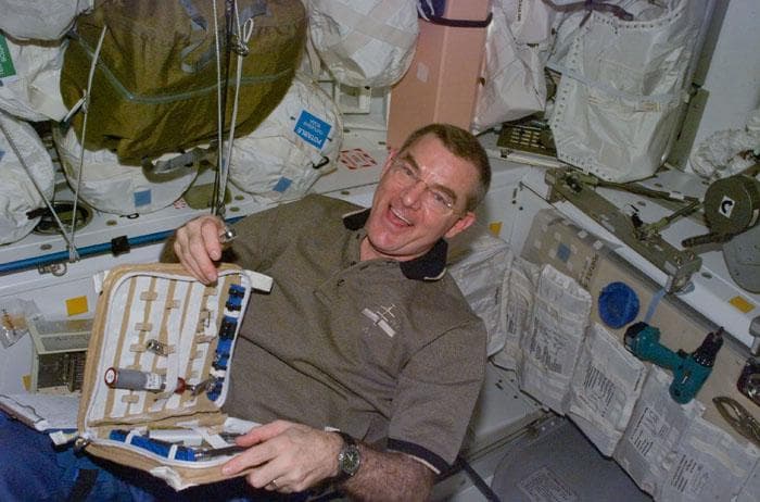 NASA image: Voss retrieves a small tool from a tool kit in ISS Node 1/Unity