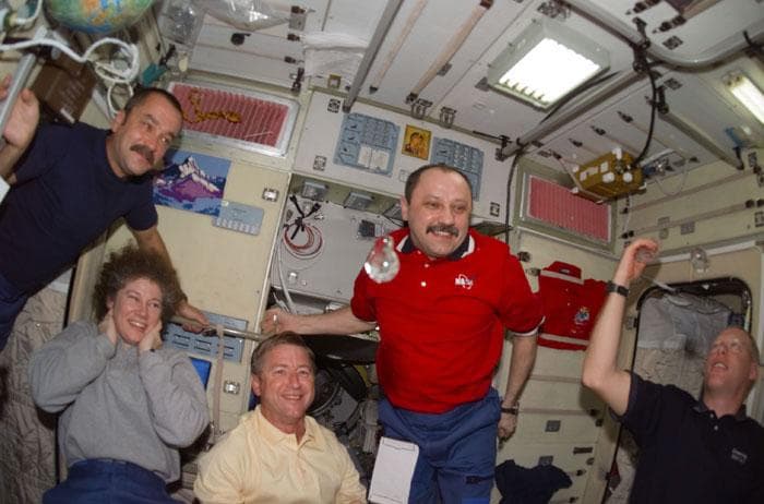 NASA image: STS-105, Expedition Two and Three crews share a light moment with liquid bubbles