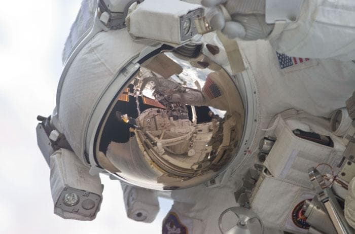NASA image: Close-up of helmet and visor of Barry during the first EVA