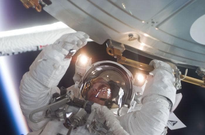 NASA image: Barry grabs a handrail on ISS during the first EVA
