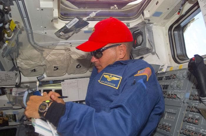 NASA image: Sturckow in the orbiter flight deck gives instructions to the EVA astronauts