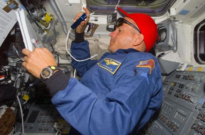 NASA image: Sturckow in the orbiter flight deck gives instructions to the EVA astronauts
