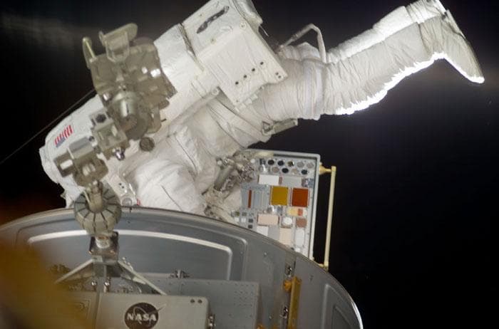 NASA image: Forrester installs a MISSE PEC on the Airlock Crewlock endcone during EVA