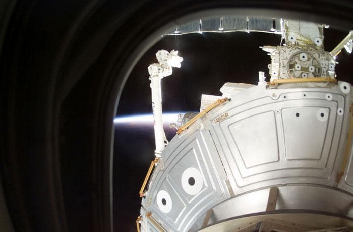 NASA image: SSRMS/Canadarm2 and ISS backdropped by Earth limb