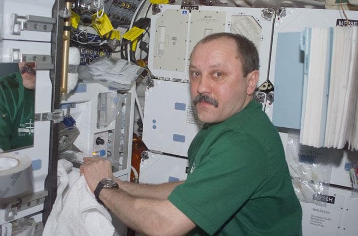 NASA image: Usachev prepares a drink at the middeck galley