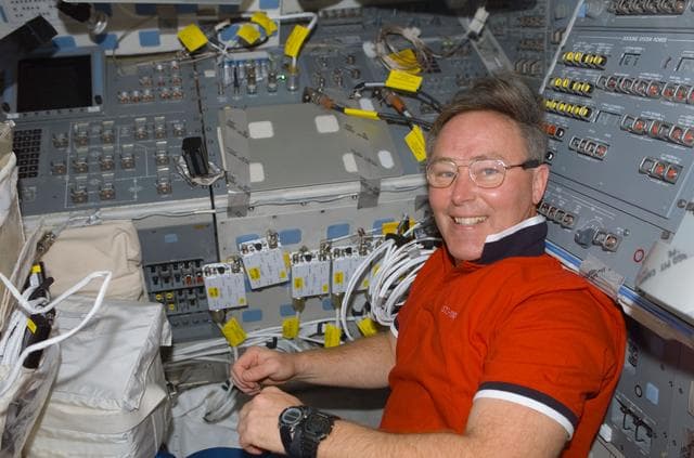 NASA image: MS Ross poses on the flight deck of Atlantis during STS-110