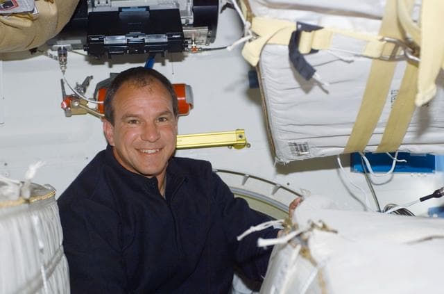 NASA image: Commander Bloomfield poses on the middeck of Atlantis during STS-110