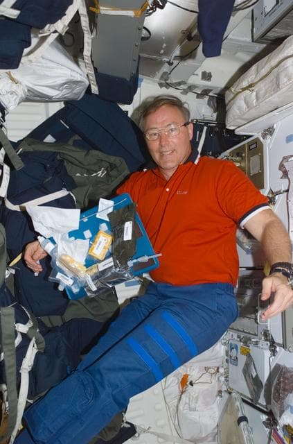 NASA image: MS Ross eats a meal on the middeck of Atlantis during STS-110