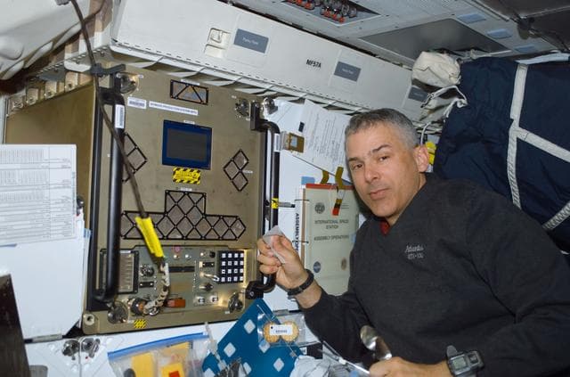 NASA image: MS Morin works at the BPS experiment on the middeck of Atlantis during STS-110