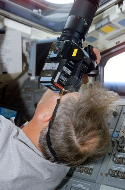 NASA image: MS Ross uses a Hasselblad camera on the flight deck of Atlantis during STS-110