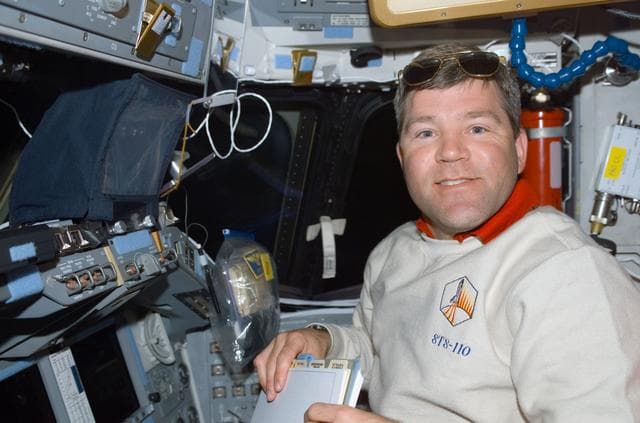 NASA image: Pilot Frick works at the pilot's workstation on the flight deck of Atlantis during STS-110