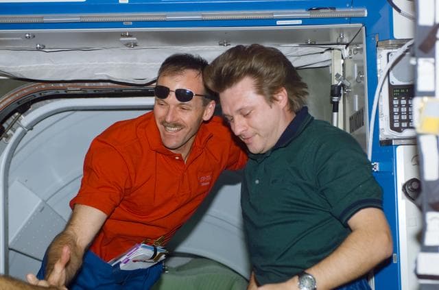 NASA image: Onufrienko welcomes Smith in Destiny during STS-110's initial ingress into the ISS