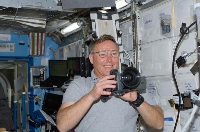 NASA image: Ross uses a video camera in Destiny during STS-110's initial ingress into the ISS