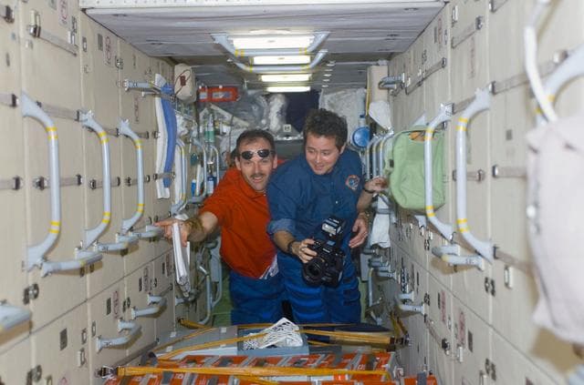 NASA image: Bursch and Smith pose in the FGB during STS-110's visit to the ISS