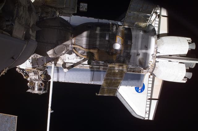 NASA image: View of the Soyuz and Atlantis' payload bay taken during STS-110's visit to the ISS