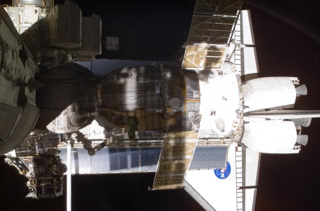 NASA image: View of the Soyuz and Atlantis' payload bay taken during STS-110's visit to the ISS