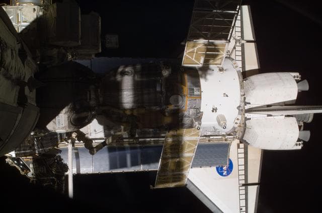 NASA image: View of the Soyuz and Atlantis' payload bay taken during STS-110's visit to the ISS