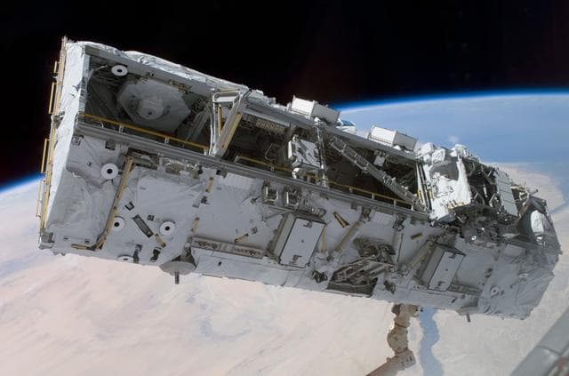 NASA image: View of the S0 Truss being moved into installation position by the SSRMS during STS-110