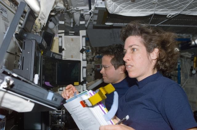 NASA image: Bursch and Ochoa at the SSRMS controls in Destiny during S0 Truss installation on the ISS