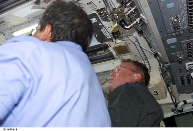 NASA image: STS-114 Mission specialists Thomas and Camarda on aft flight deck.