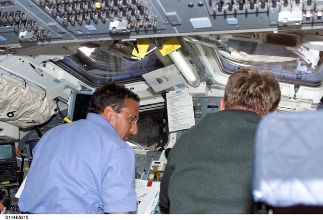 NASA image: STS-114 Mission specialists Thomas and Camarda on aft flight deck.