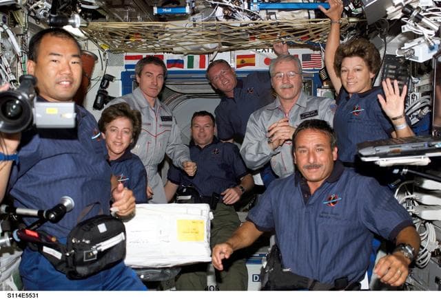 NASA image: STS-114 and Expedition 11 crew gathered in the Destiny laboratory module