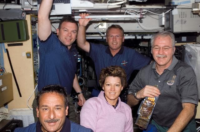 NASA image: STS-114 and Expedition 11 crew pose for a photo in Zvezda Service module