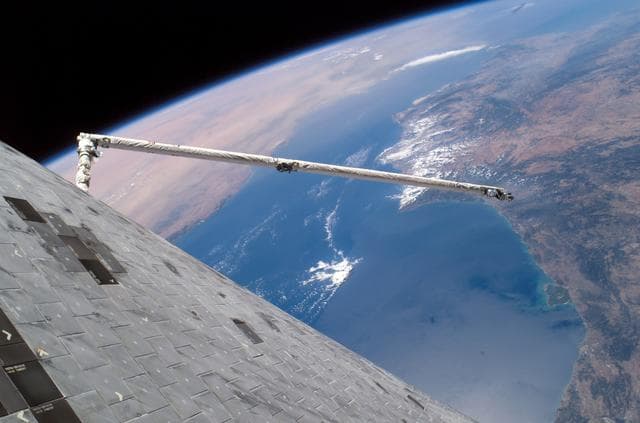 NASA image: Orbiter Boom Sensor System and TPS tiles on orbiter Discovery as seen during EVA 3