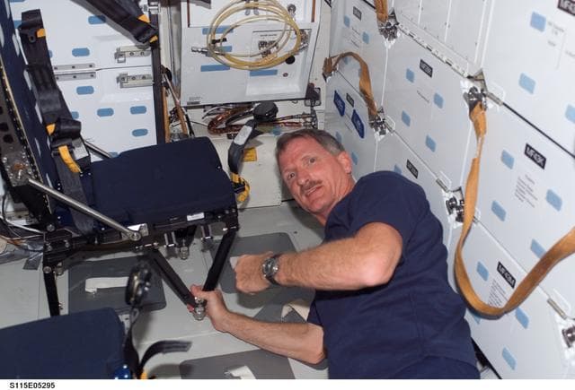 NASA image: STS-115 MS Tanner prepares to remove LES seat on Atlantis Middeck