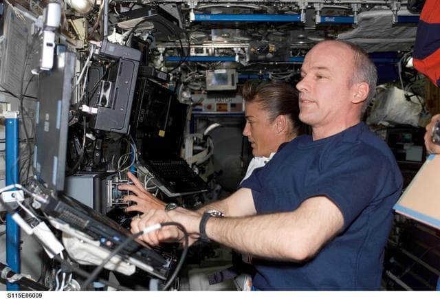 NASA image: Expedition 13 Commander Williams and STS-115 MS Stefanyshyn-Piper work at the SSRMS in the U.S. Laboratory