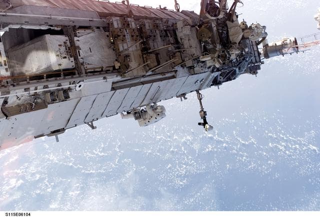 NASA image: STS-115 MS Stefanyshyn-Piper releases PVR cinches and winch PIP pins on the P3/P4 Truss during EVA