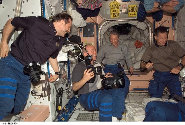 NASA image: STS-115 and Expedition 13 crewmembers in the Node 1 during Joint Operations