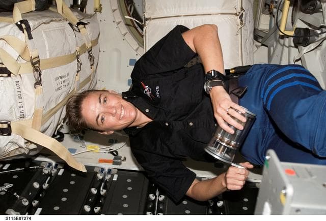 NASA image: STS-115 MS MacLean holds Yeast GAP in the FWD MDDK of the Space Shuttle Atlantis during Joint Operations
