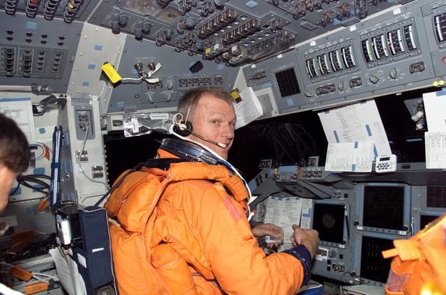 NASA image: STS-115 Commander looks over checklist in the FD on Space Shuttle Atlantis prior to entry