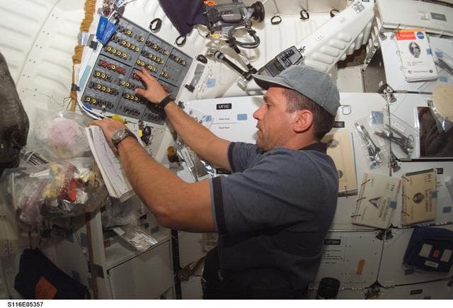 NASA image: STS-116 MS Patrick works at control panel in the MDDK on Space Shuttle Discovery