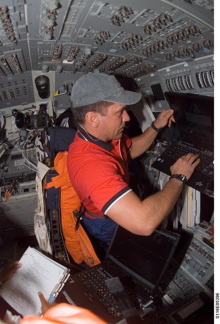 NASA image: STS-116 Pilot Oefelein working on laptop computer in the aft FD on Space Shuttle Discovery
