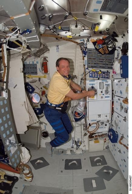 NASA image: STS-116 MS Fuglesang prepares meal in the FWD MDDK on Space Shuttle Discovery