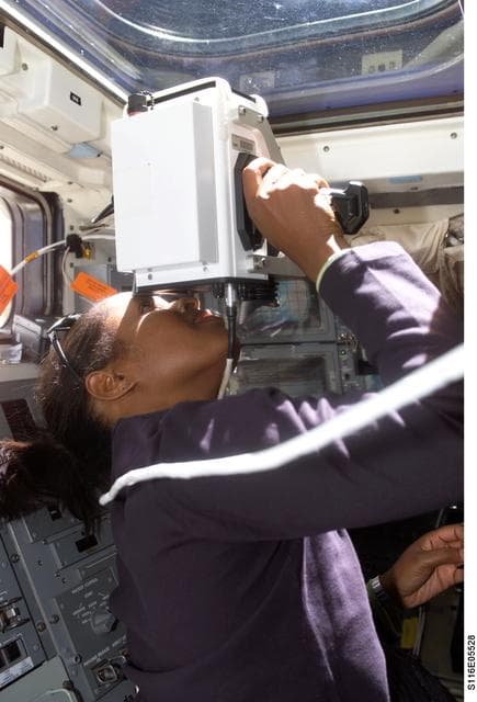 NASA image: STS-116 MS Higginbotham uses handheld ranging device on the aft FD on Space Shuttle Discovery