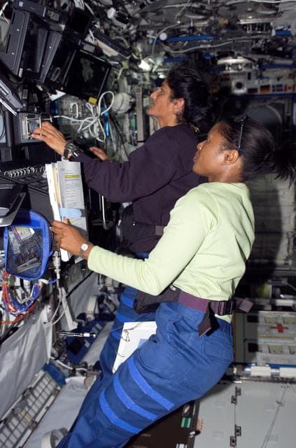 NASA image: Crewmembers Higginbotham and Williams work at the SSRMS in the U.S. Laboratory during Joint Operations