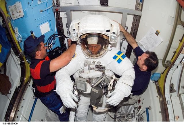 NASA image: STS-116 MS Fuglesang wearing EMU in the A/L on the ISS
