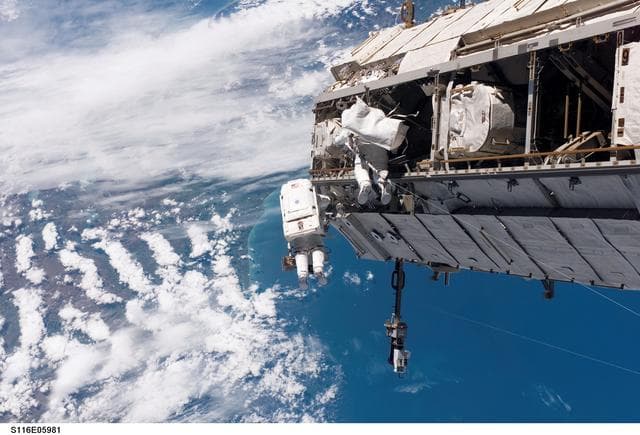 NASA image: STS-116 MS Curbeam, Jr., and Fuglesang work on S1 Truss during EVA 1