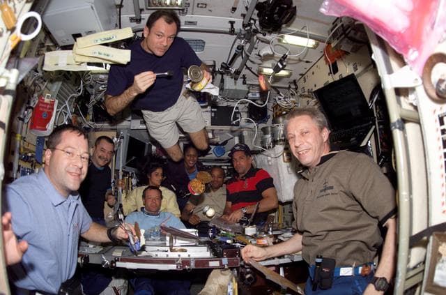 NASA image: Expedition 14 / STS-116 Crewmembers enjoy meal in the SM during Joint Operations