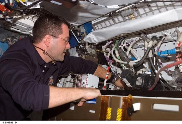 NASA image: STS-116 MS Patrick works on HRF rack in the U.S. Laboratory during Joint Operations