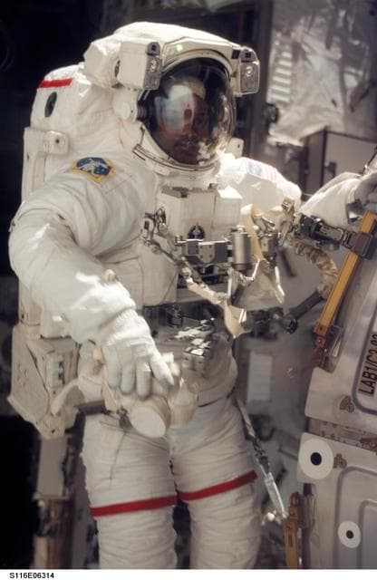 NASA image: STS-116 MS Curbeam,Jr.,works at the U.S. Laboratory during EVA 2