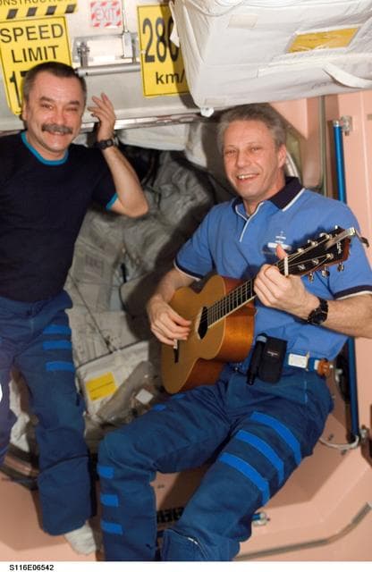 NASA image: STS-116 FE Reiter plays guitar in the Node 1 during Joint Operations