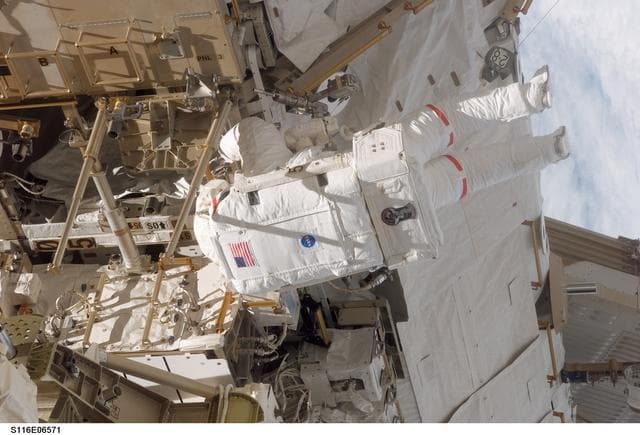 NASA image: STS-116 MS Curbeam,Jr.,works on the S0 and S1 Truss during EVA 3