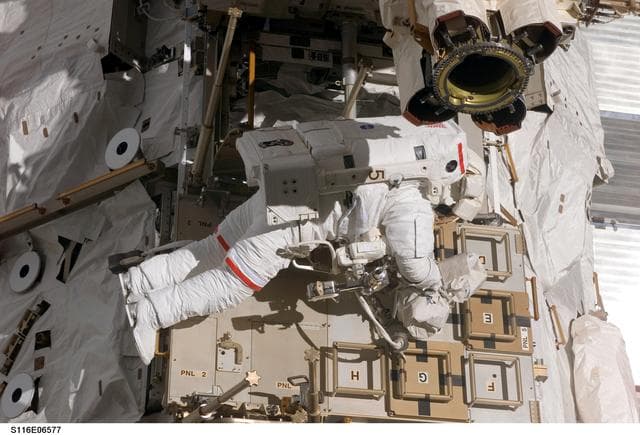 NASA image: STS-116 MS Curbeam,Jr.,works on CETA Cart during EVA 3
