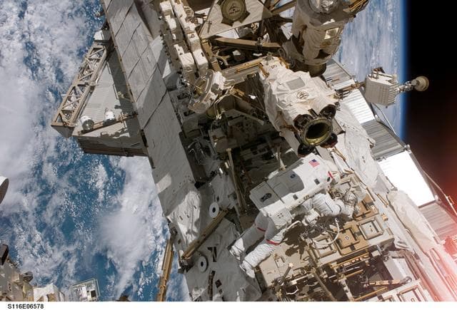 NASA image: STS-116 MS Curbeam, Jr., works on CETA Cart during EVA 3